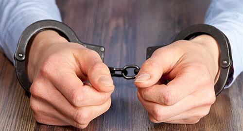 Picture of man arrested in handcuffs